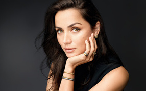 Кареглазая девушка актриса Ана де Армас на сером фоне