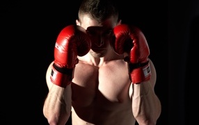 Man standing in red boxing gloves