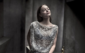 Рыжеволосая актриса Эмма Стоун в блестящем платье в серой комнате