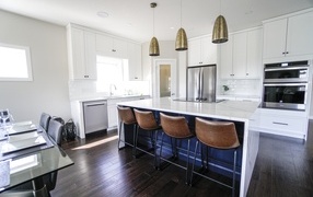 White furniture in the kitchen with leather chairs