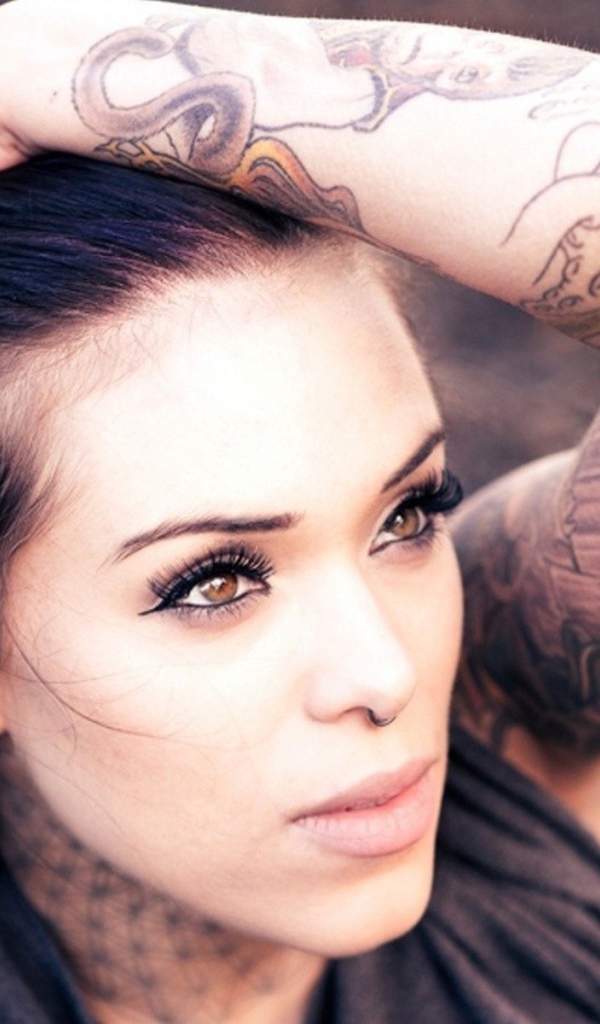 Девушка с цветной татуировкой на руке