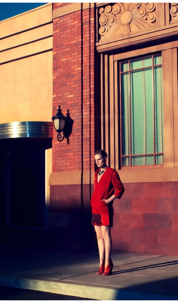 Photo of a girl in a red on the building background