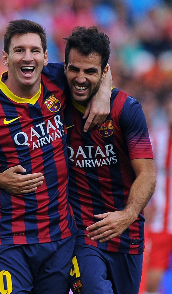 The football players of Barcelona Francesc Fabregas and Lionel Messi