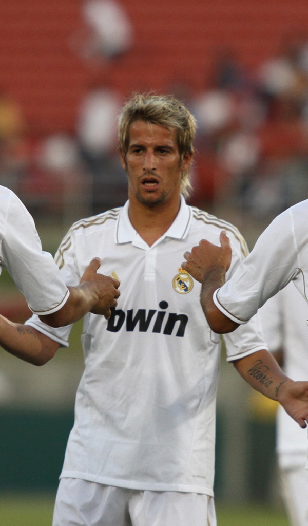 The player of Real Madrid Fábio Coentrão surrounded by his team