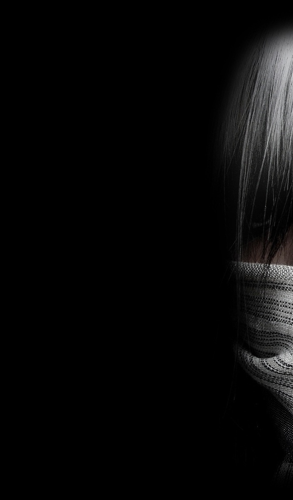 The person in a mask on black wallpaper