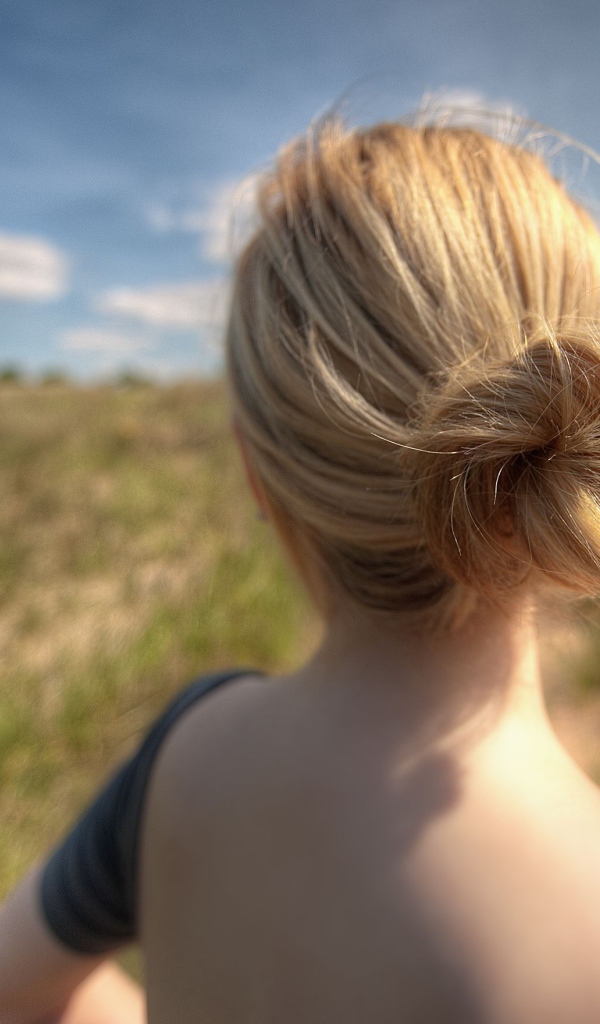 Девушка с цветами в волосах в поле