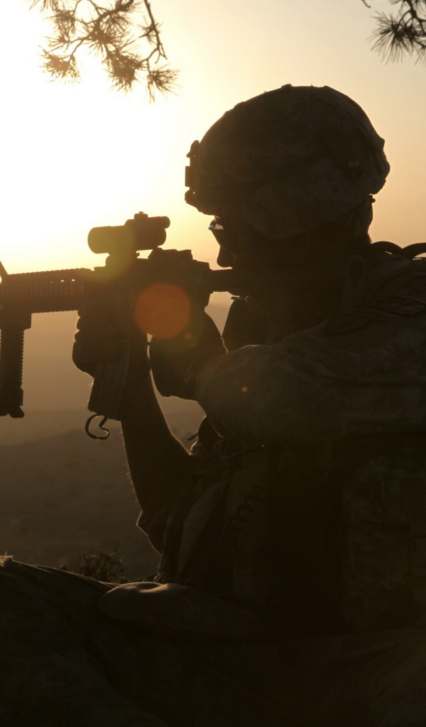 Солдат с оружием на закате