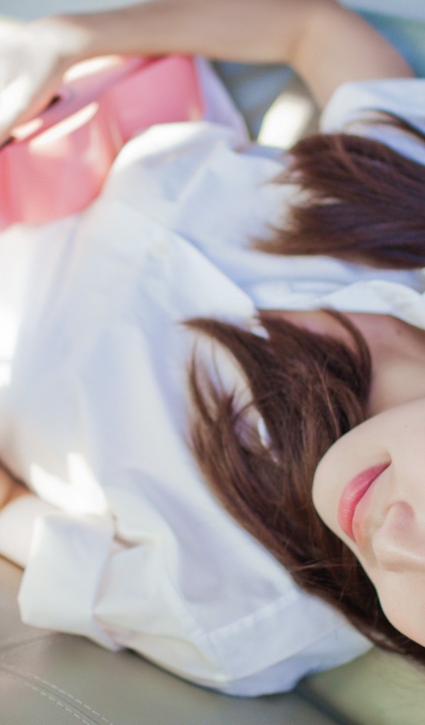 Брюнетка и розовая гитара на диване