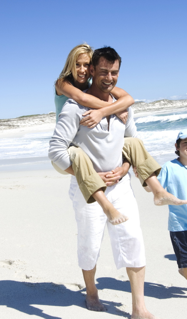 Семья гуляет по берегу