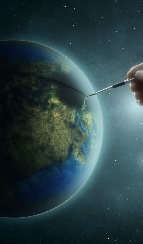 Рука рисует на планете