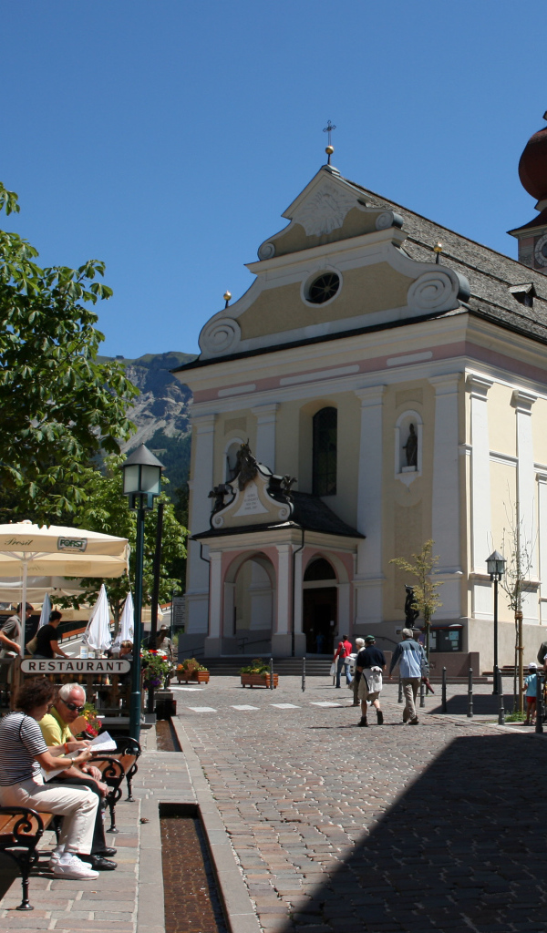 Церковь на площади на курорте Ортизей, Италия