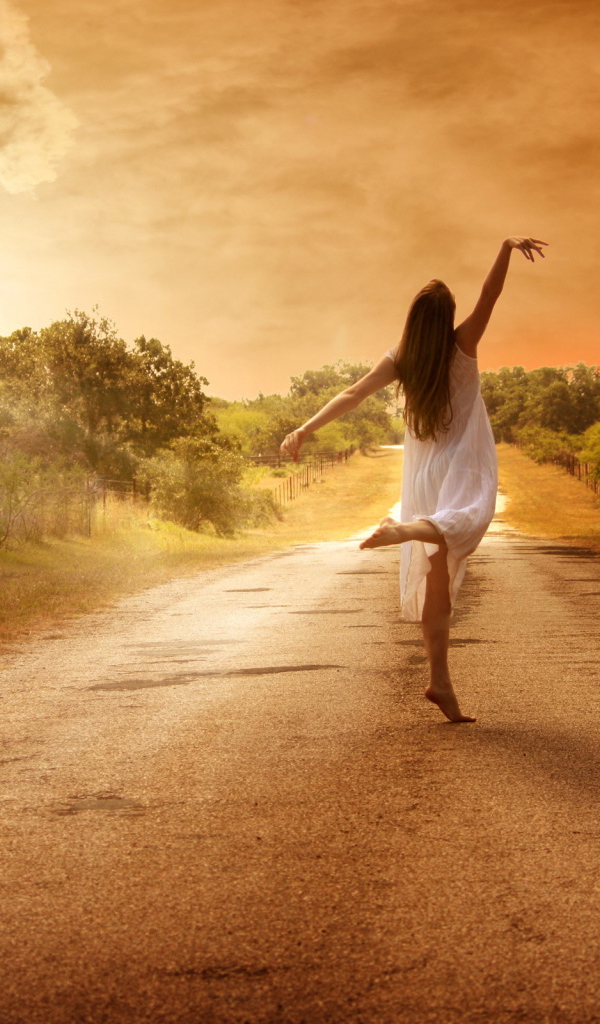 Балерина на дороге на фоне заката