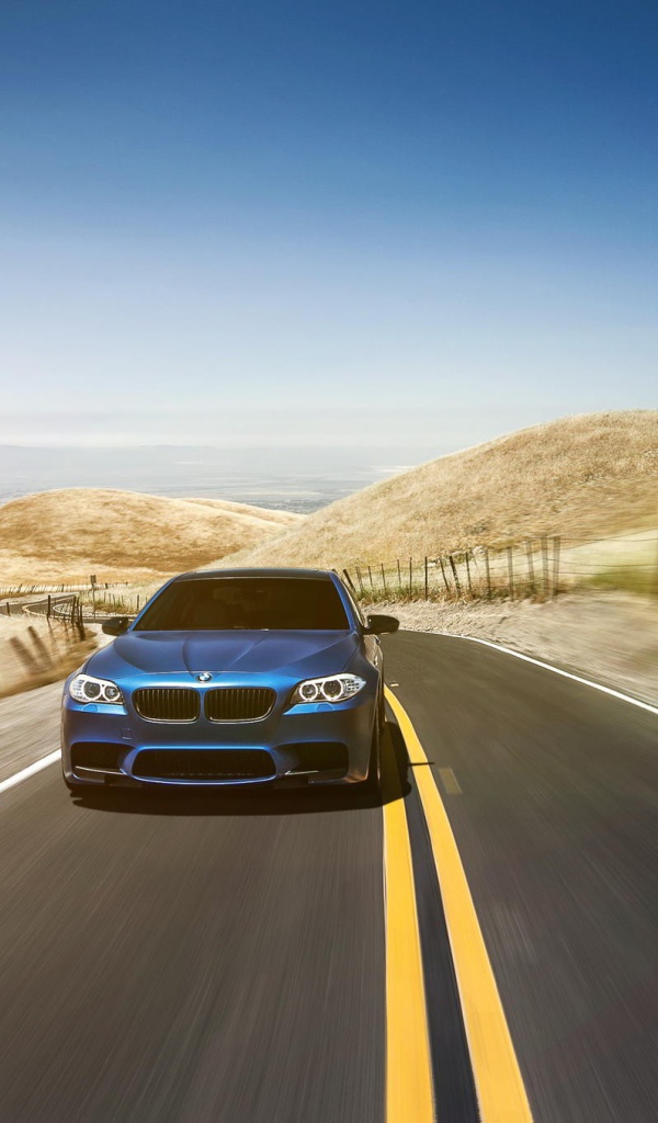 Голубой BMW мчится по шоссе в пустыне