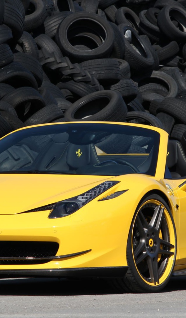 Желтый суперкар Ferrari 458 на фоне покрышек