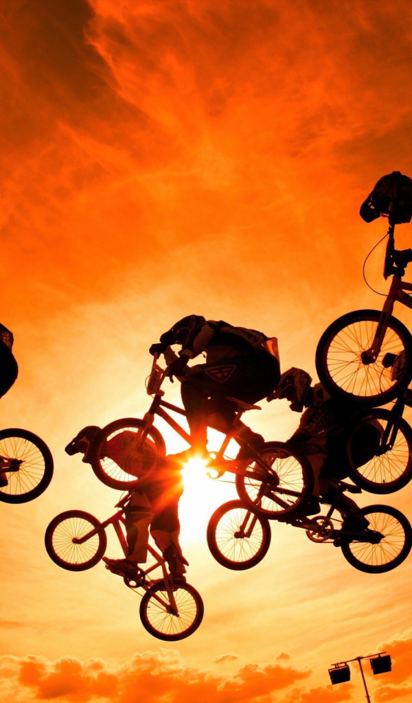 Велосипедисты на фоне солнца