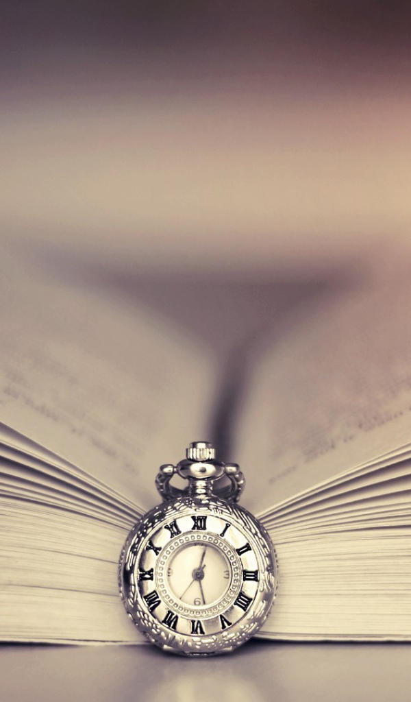 Часы на цепочке в открытой книге