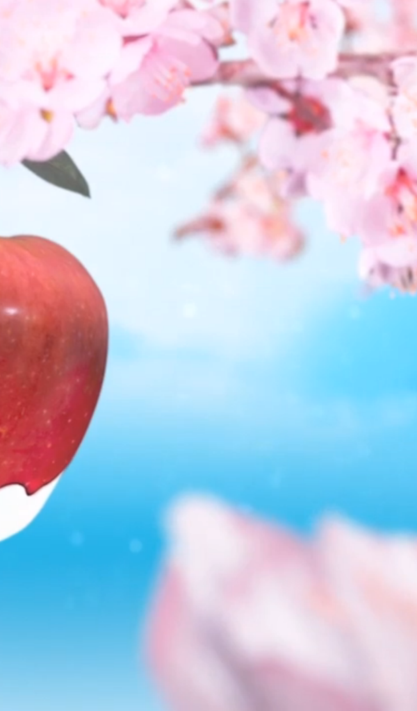 Красное яблоко среди розовых цветов