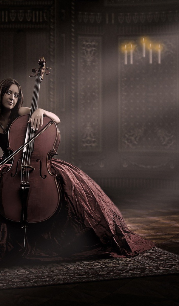 Девушка в роскошном платье играет на виолончели