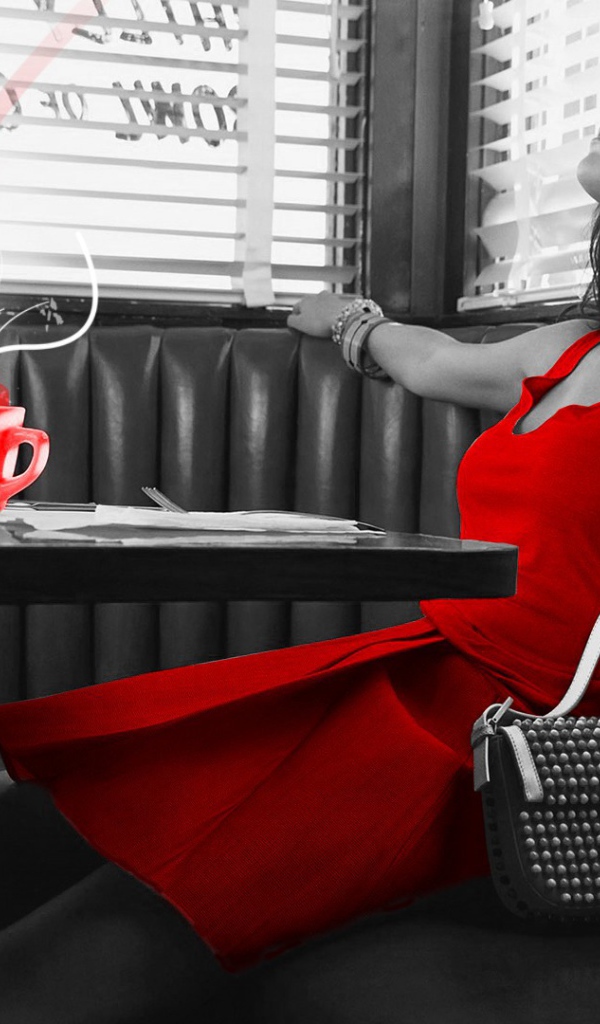 Girl in red dress sitting in a cafe