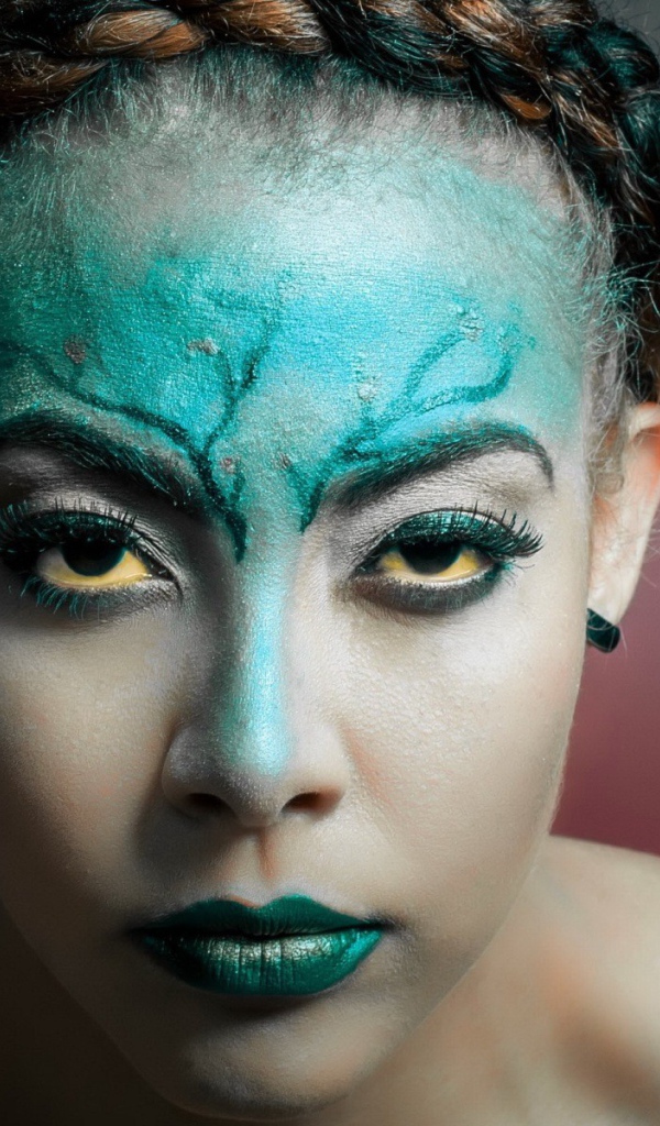 Зеленая краска на лице у девушки