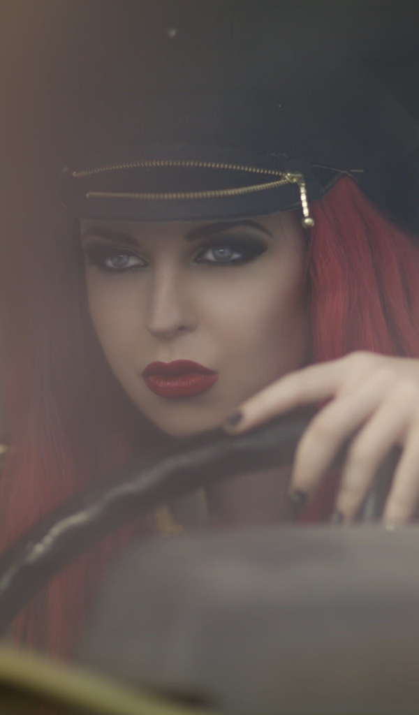 Девушка в фуражке за рулем