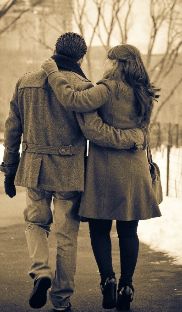 Влюбленные гуляют по зимнему парку