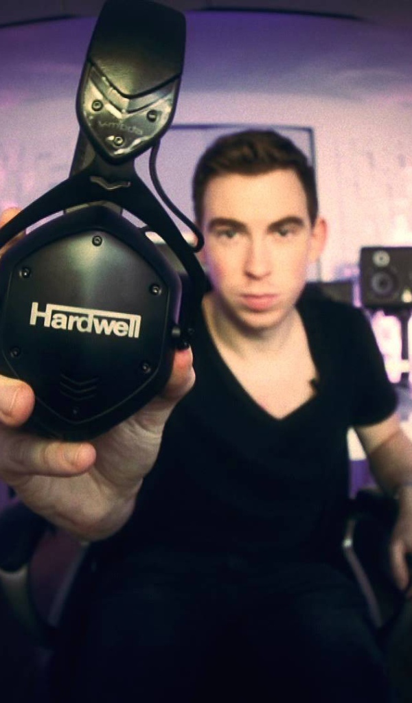 Музыкант держит в руке наушники Hardwell