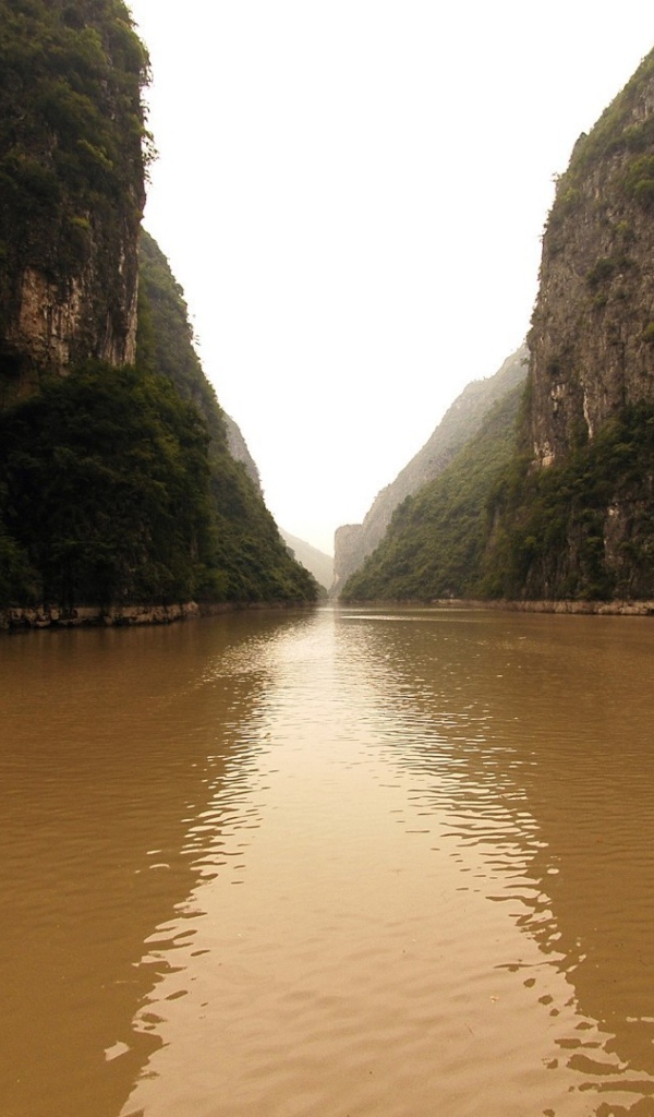 Коричневая вода реки между скал