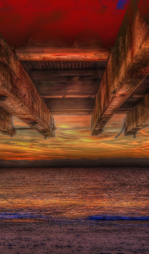 Вид на закат из-под навеса на пляже