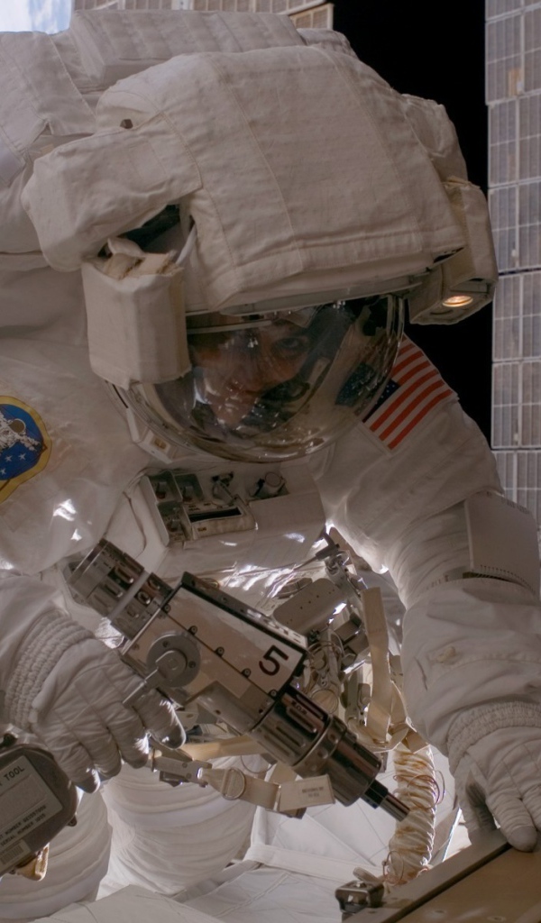 Космонавт на орбите выполняет ремонт