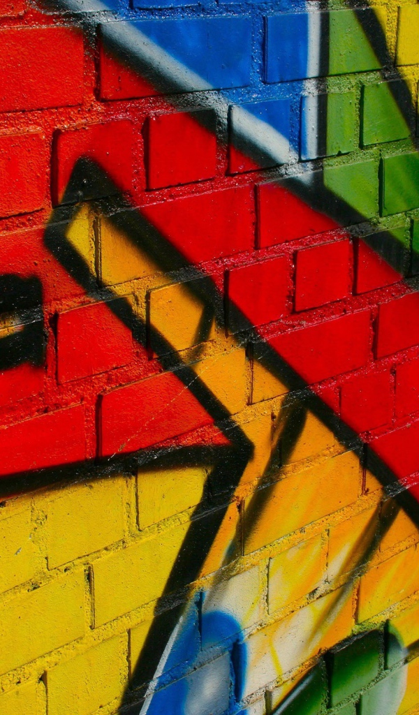 Some of the bright graffiti on a brick wall