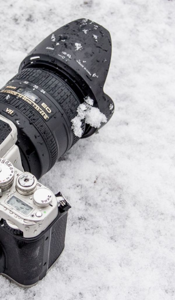 Фотоаппарат лежит на снегу