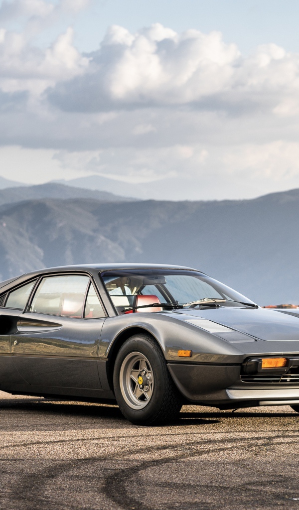 Supercar Ferrari 308 gts gray in the background of the mountains