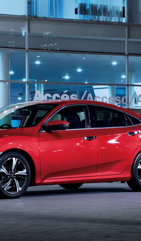 Стильный красный автомобиль Honda Civic в автосалоне