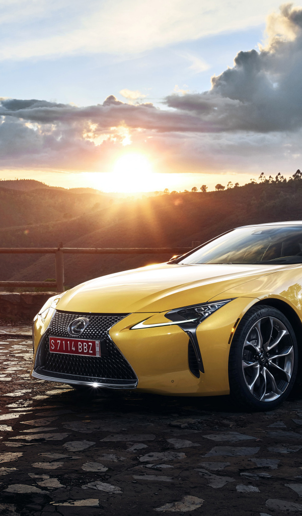 Желтый автомобиль Lexus LC 500  на фоне заката 