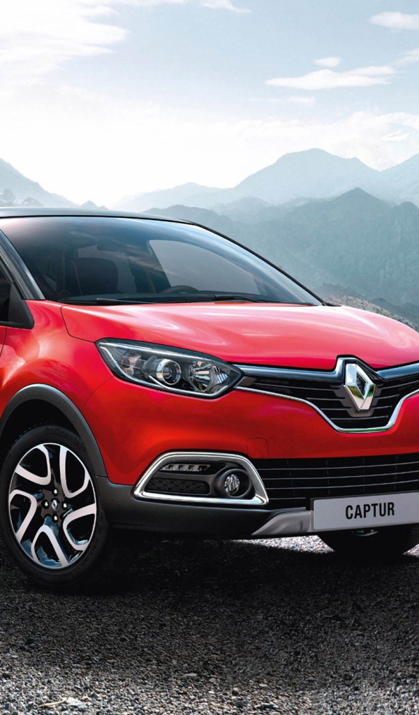 Красный автомобиль внедорожник Renault Captur на фоне гор