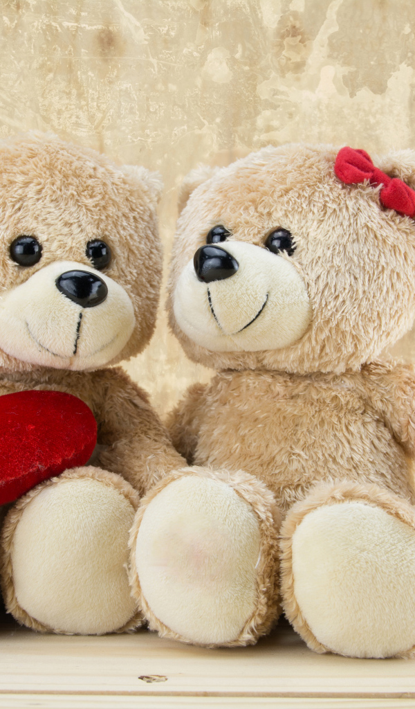 Два милых плюшевых мишки с красным сердцем