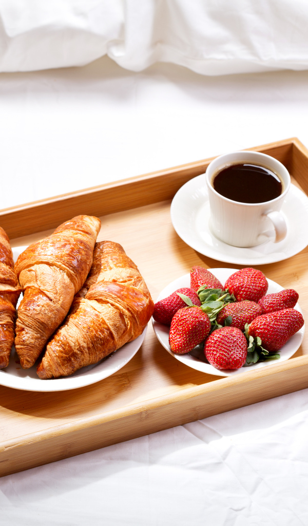 Круассаны, клубника, апельсиновый сок и кофе на завтрак