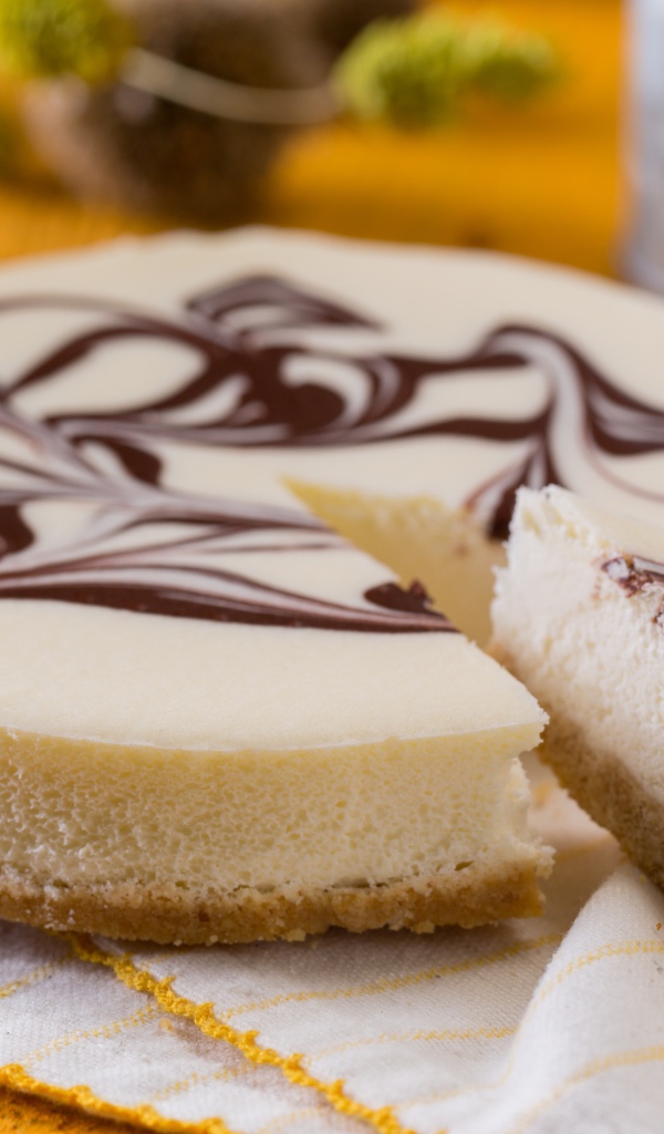 Аппетитный торт с шоколадным рисунком стоит на столе