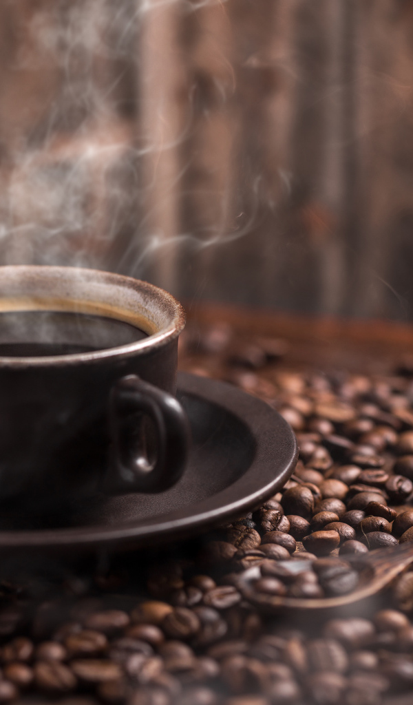 Чашка горячего ароматного кофе с кофейными зернами