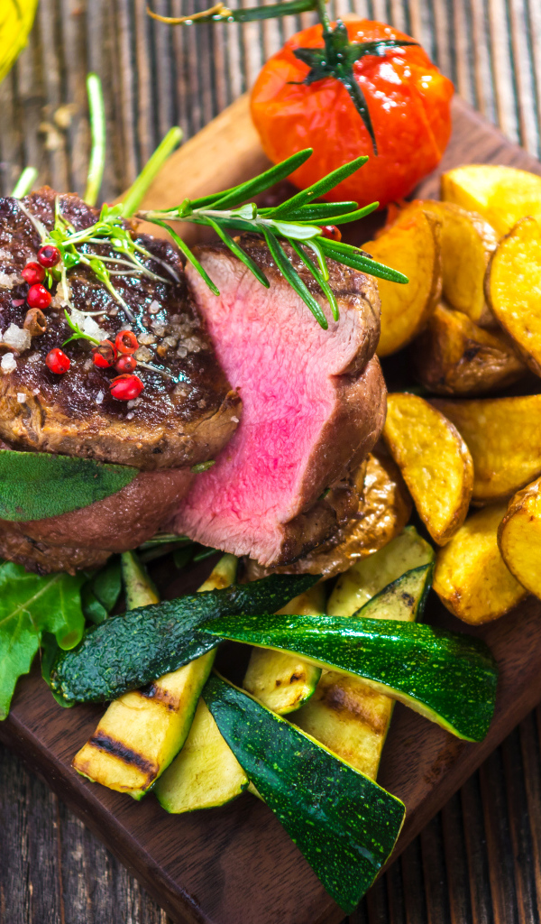 Сочный кусок мяса с картофелем, кабачками и помидорами