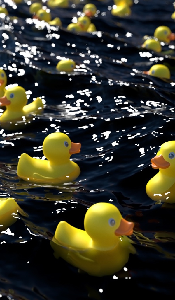 Много желтых резиновых уточек в воде