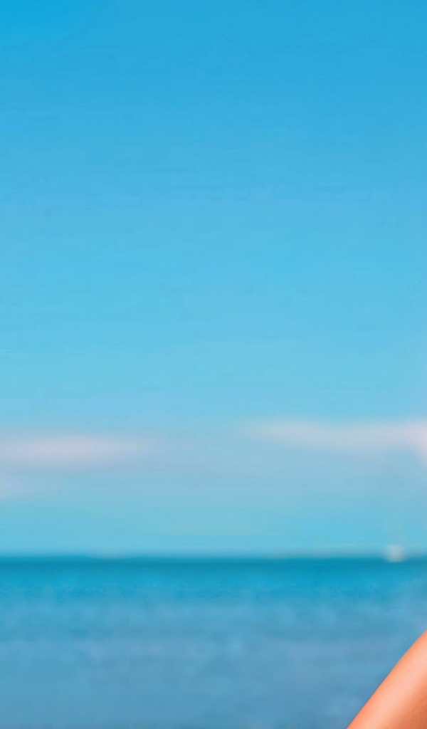 Горячая молодая девушка в черном купальнике на фоне океана