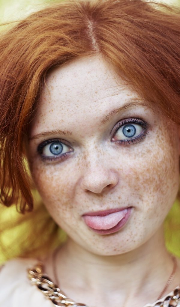 Рыжеволосая девушка с веснушками на лице
