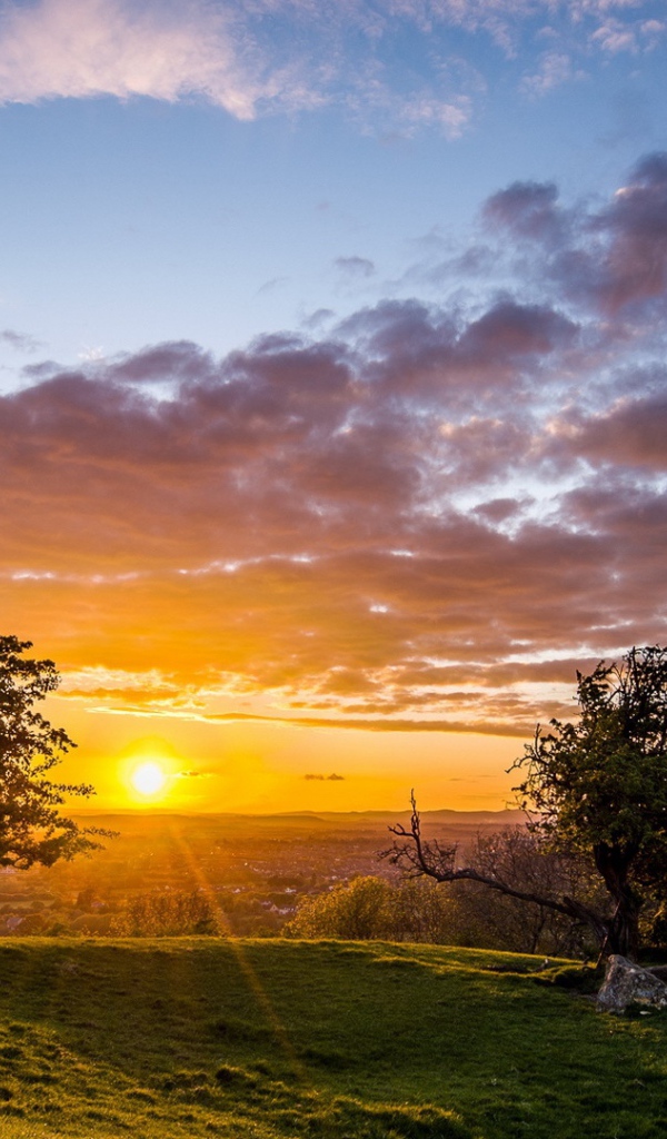 Летний рассвет солнца в облачном небе укрывает землю