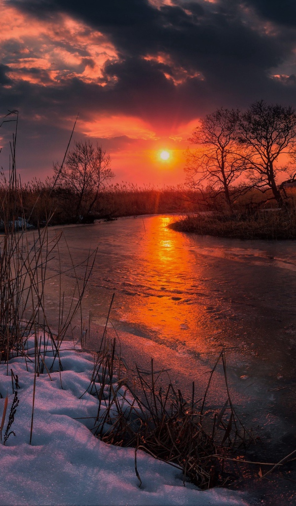 Sunset over an ice-covered river