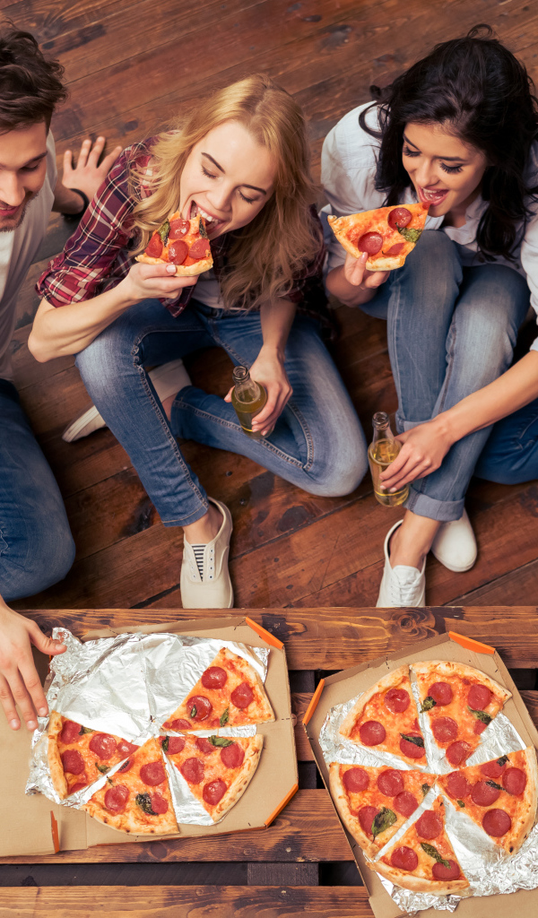 A company of friends eating an appetizing pizza