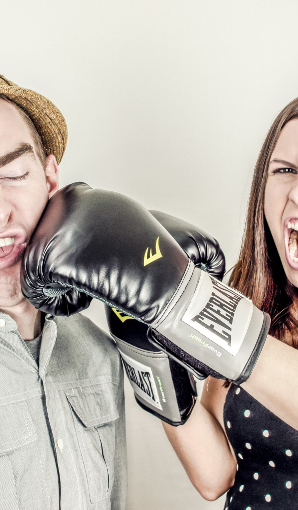 A terrible girl in boxing gloves beats a guy