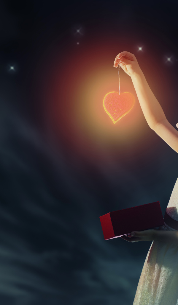 Девочка в красивом белом платье держит в руках сердечко