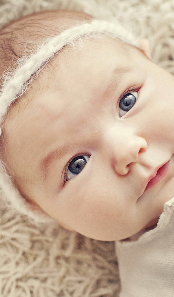 Красивая голубоглазая малышка с повязкой на голове